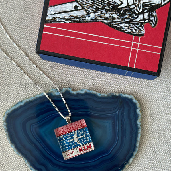 Square glass pendant featuring a genuine 1959 Netherlands postage stamp (Scott #371) celebrating the 40th anniversary of KLM Royal Dutch Airlines, set in a sterling silver frame