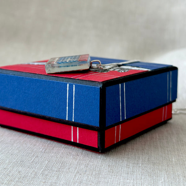 Square glass pendant featuring a genuine 1959 Netherlands postage stamp (Scott #371) celebrating the 40th anniversary of KLM Royal Dutch Airlines, set in a sterling silver frame